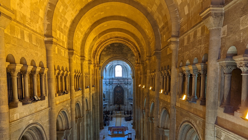 looking down a row of pews from upstairs