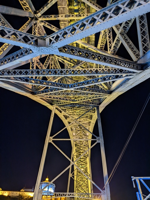 A steel arch bridge, seen from below
